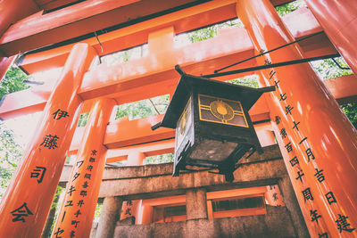 Low angle view of traditional building against orange sky