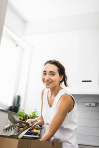 Portrait of smiling woman in kitchen