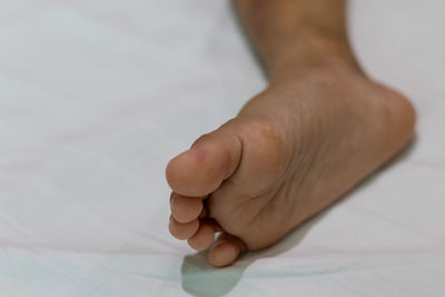 Low section of person legs on bed