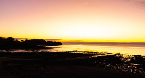 Scenic view of sea against clear sky during sunset