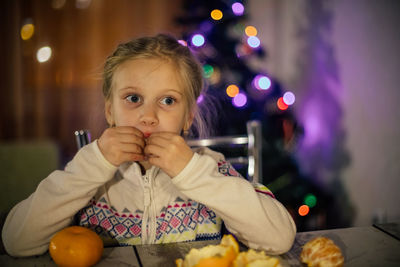 Portrait of happy girl with ice cream on table