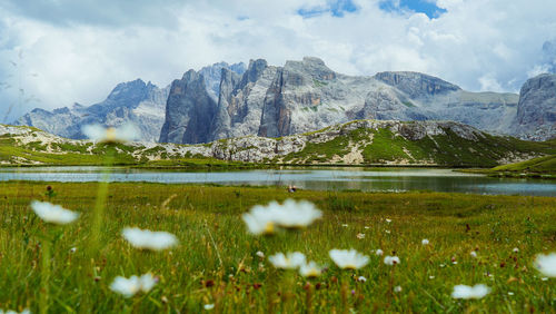 Scenic view of lake by mountains against sky