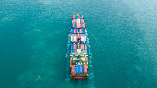 High angle view of cargo containers in ship sailing on sea