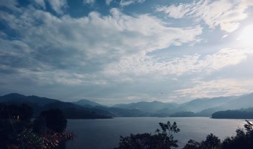 Scenic view of lake and mountains against sky