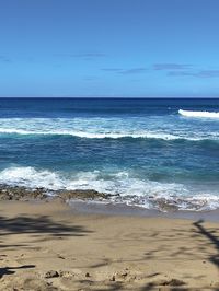 Scenic view of sea against clear blue sky