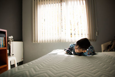 Portrait of boy on bed at home