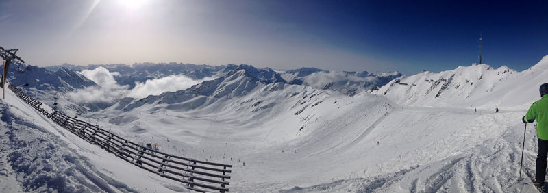 Scenic view of snow covered mountains against sky