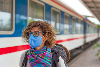 Portrait of woman in train at railroad station platform