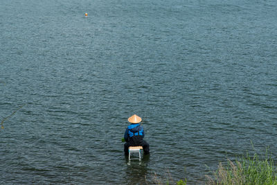 Rear view of man in sea