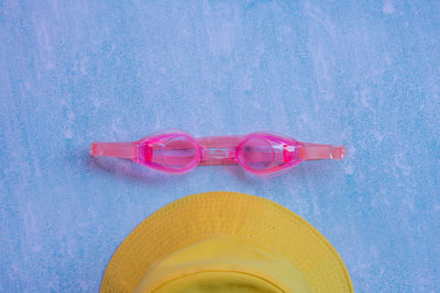 High angle view of sunglasses on table by swimming pool