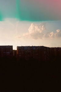 Buildings in city at sunset