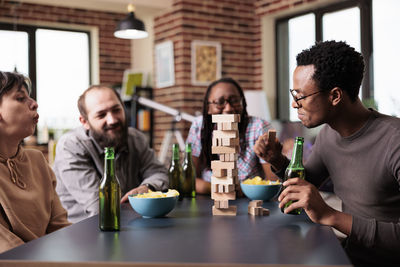 Business colleagues playing with building blocks on table