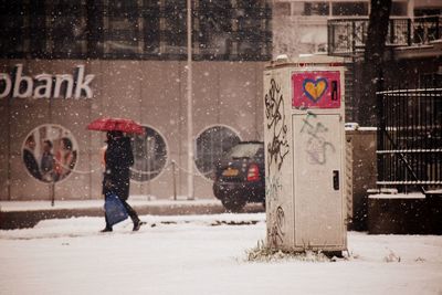 Woman crossing road in winter