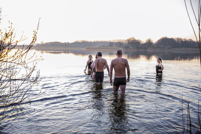 Male and female friends in water