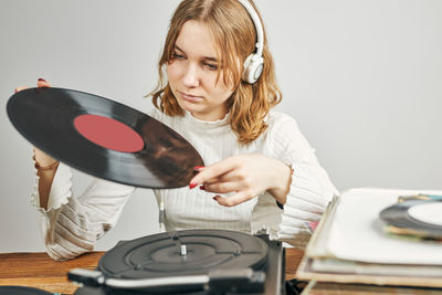 Listening to music from vinyl record. playing music. retro style. vintage. analog sound. passion