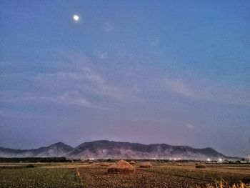 Scenic view of field against blue sky