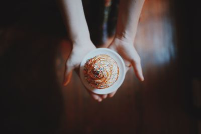 Close-up of hand holding cupcake