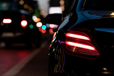 Close-up of illuminated car on road at night