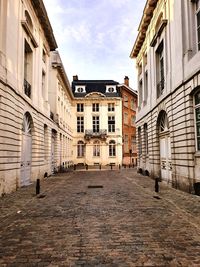 Street amidst buildings in town against sky