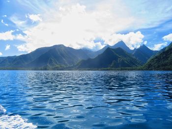 Scenic view of lake and mountains against sky