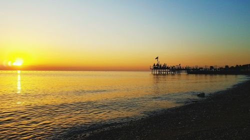 Scenic view of sea against romantic sky at sunset