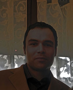 Close-up portrait of young man against wall