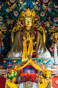 Low angle view of statue against temple building