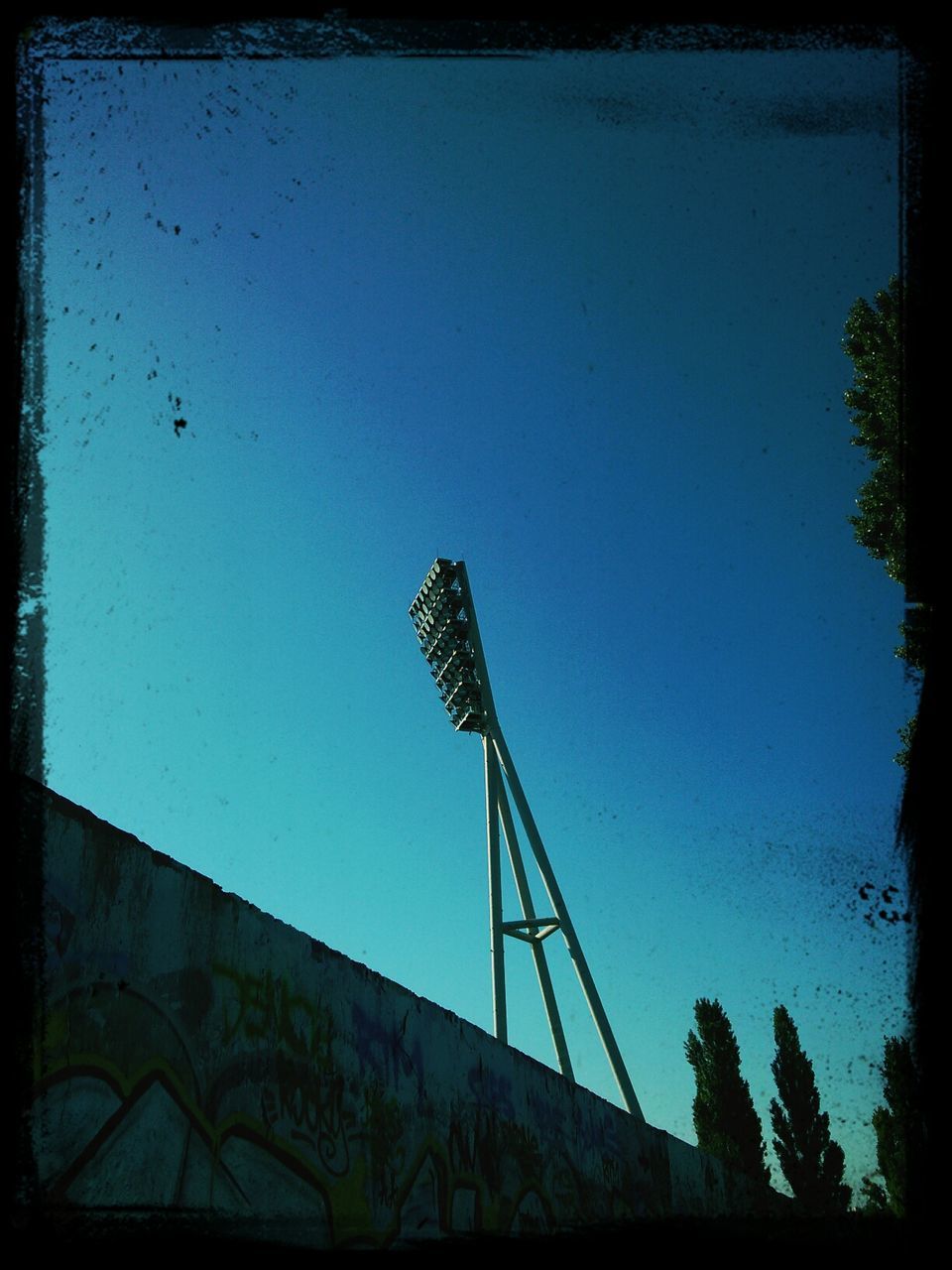 transfer print, low angle view, auto post production filter, clear sky, blue, built structure, tree, architecture, copy space, sky, silhouette, building exterior, vignette, outdoors, tall - high, no people, day, tower, dusk, sunlight