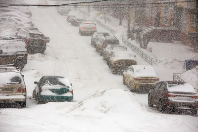 Snow covered street in city