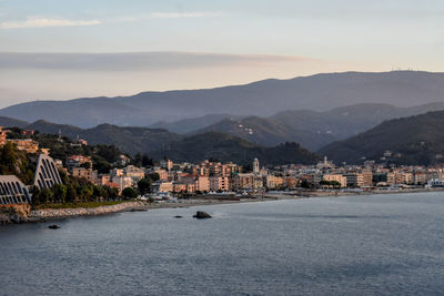 Townscape by sea against sky