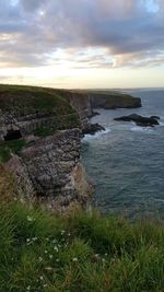 Scenic view of sea against cloudy sky