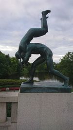 Statue of building against cloudy sky