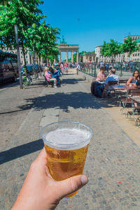 Cropped image of people with drink in glass