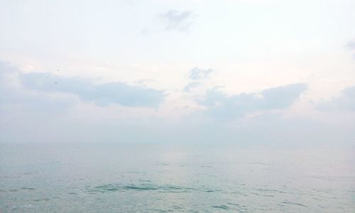 Scenic view of sea against cloudy sky