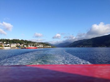 View of boats in sea against cloudy sky