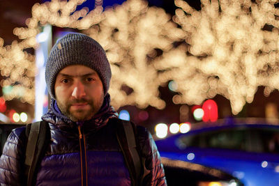 Portrait of young man in city in winter