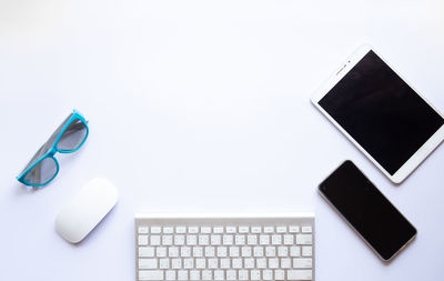 Directly above view of laptop on table against white background