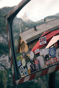 Close-up of old text on wood against sky