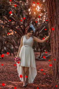 Rear view of woman standing by plants