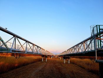 Bridge over road against clear sky