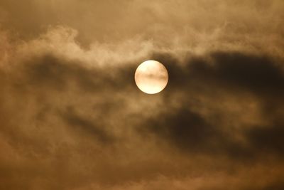 Low angle view of sun coming out of the clouds