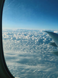 Aerial view of cloudscape seen from airplane window