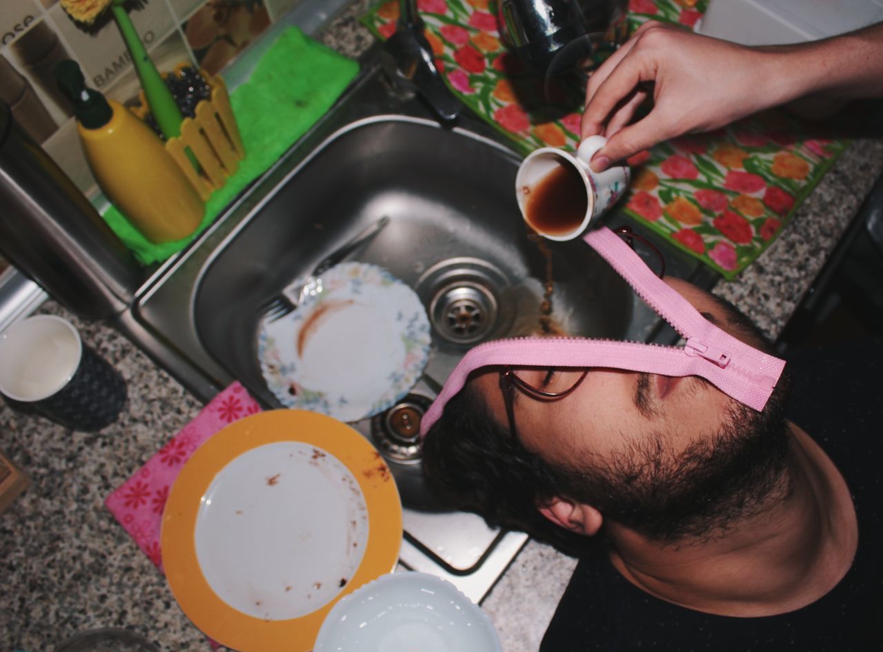 HIGH ANGLE VIEW OF PEOPLE HAVING FOOD IN KITCHEN