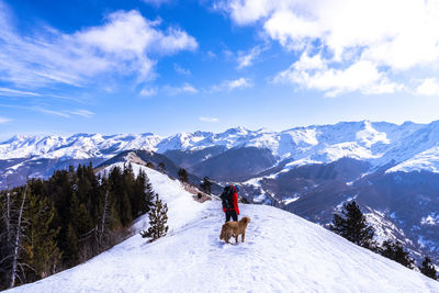 Man on snowcapped mountain against sky