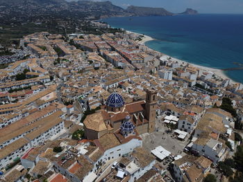 Drone view of altea with white houses, coastal charm, and mediterranean sea along the costa blanca