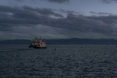 Boat sailing in sea against sky