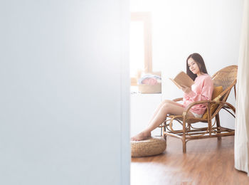 Woman sitting on chair at home