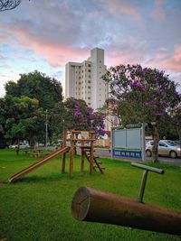 Trees and plants in park against buildings in city