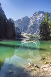 Scenic view of lake and mountains against clear sky