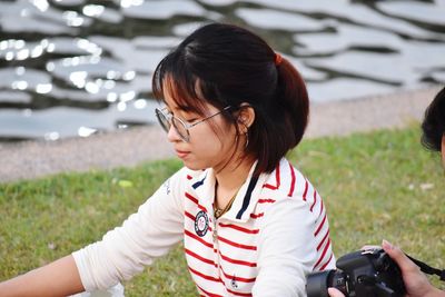 Woman photographing on field